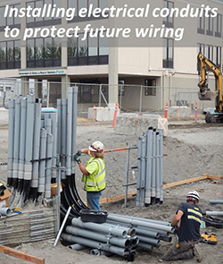 Installing electrical conduits to protect future wiring. 