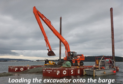 Outfall pipe installation in tidal flat and construction barge in Oak Harbor Bay
